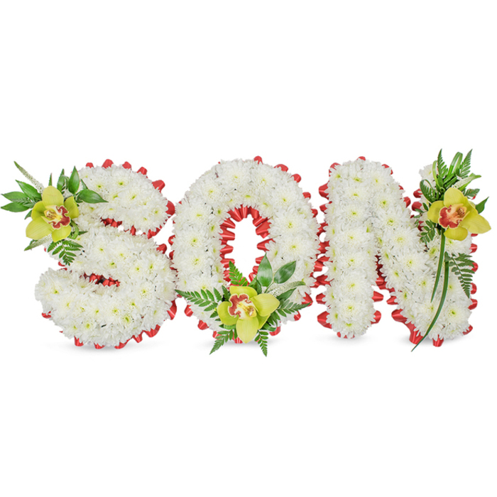A refined and heartfelt floral tribute spells SON in three-dimensional block letters, each letter entirely covered in small, immaculate white chrysanthemum blooms whose compact petals form a soft, sculptural surface. The edges of the letters are carefully traced with a continuous band of vivid red ribbon, folded into small scalloped loops that provide a crisp, contrasting outline against the white field and accentuate the roundness of the O. Placed with botanical precision, a lime-green Cymbidium orchid sits at the upper left of the S, another at the base of the O, and a third near the upper right of the N; each orchid displays a mellow yellow-green hue and a reddish-brown marking within its throat, contributing a gentle focal warmth. A mix of glossy foliage and fine fern fronds weaves through and around the letters, lifting the overall height and lending a natural cascade that softens the typographic form. Under soft, neutral lighting the chrysanthemum petals read as pure and calm, while the orchids' satiny texture and the ribbon's bright colour give the tribute depth and emotional clarity. This arrangement is intended for funeral display, a graveside tribute, or a memorial service in the Nine Elms area-close to landmarks such as Battersea Power Station and the riverside walk-where families seek a personal and sympathetic expression. From a florist's perspective, the piece balances tradition and craft: precise flower placement, harmonious colour contrast, and tactile variety that together convey love, remembrance, and quiet honour for a beloved son.