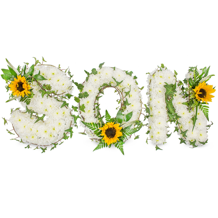 A sculpted memorial piece, photographed against a pure white backdrop, where the word SON is rendered in bold, three-dimensional letters entirely veneered with small, immaculate white chrysanthemums. The chrysanthemums form a soft, tactile field across each letter-dense at the core, softly feathered at the edges-so the surface reads like a cloud of petals when viewed up close. Threaded through and around these white forms are sprigs of dark green ivy-familiar, glossy leaves curling and weaving to give depth and a continual, living rhythm across the composition-plus lighter fern fronds and pointed foliage that break the white plane with delicate texture. Three sunflowers punctuate the design: one placed on the upper left curve of the S, another nestled at the lower centre of the O amid the ferns, and the third set on the upper right of the N; each sunflower offers radiant yellow petals and a substantial dark brown centre that draws the eye and lends warmth to the otherwise serene palette. The lighting is soft and unobtrusive, intended to show the gentle shadows between blooms and the subtle contrasts of texture rather than dramatise the piece. As someone who has arranged tributes for families across Nine Elms, St George Wharf and the riverfront chapels, I find the composition strikes a careful balance-white chrysanthemums for peace and purity, ivy for lasting remembrance, and sunflowers as a quiet celebration of life. This arrangement is crafted with thoughtful layering and clean lines, and Flower Delivery Nine Elms prepares and photographs it precisely so the sentiment reads clearly whether viewed in a funeral programme, a condolence card image, or in-person at a service.