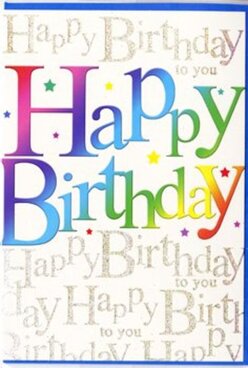 This photograph captures a festive birthday card whose lively colours would pair perfectly with a celebratory bouquet delivered across Nine Elms. Dominating the design is the phrase "Happy Birthday" in large, bold letters that run from edge to edge across the card front. Each letter carries a smooth, luminous gradient that glides from rich ruby and plum tones through tangerine and marigold, then into citrus lime, jade, teal, and royal blue, resembling a carefully composed rainbow arc over the Thames on a clear afternoon. The letterforms are thick and rounded, suggesting softness and warmth, and they appear to float slightly above the background, as if cut from glossy coloured paper. Behind this vivid message, the background is densely filled with the words "Happy Birthday to you," repeated in a fine, cursive script that curls and loops gracefully from line to line. The script appears in a soft, shimmering gold, echoing the gentle gleam of candlelight in a riverside apartment near Embassy Gardens. Light specks and tiny star-like marks, echoing tones from the main gradient, are scattered throughout, adding a hint of playful sparkle and creating the sense that confetti has just drifted down. The card surface itself looks smooth and moderately reflective, with a satin finish that allows the colours to glow without looking harsh. The overall composition feels balanced and intentional, offering both bold impact and delicate detail. It's the sort of card that could easily sit beside a birthday cake or a vase of fresh blooms from Flower Delivery Nine Elms, enhancing the moment with its joyful colour and thoughtful design, and making the recipient feel fully celebrated.